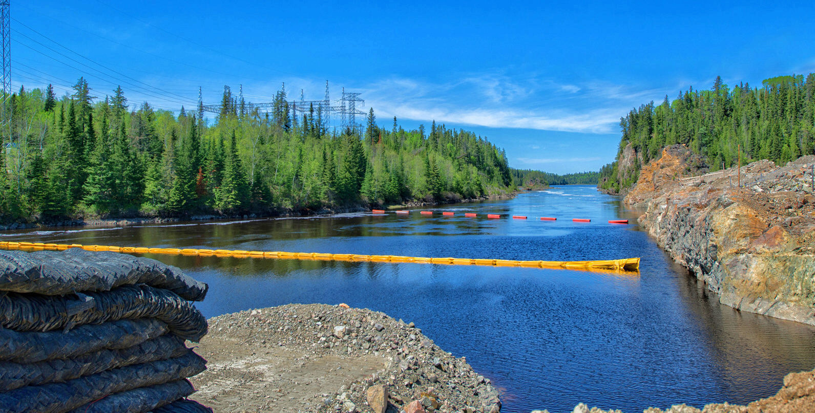 Water safety booms stretched cross a river.