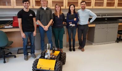 The University of Waterloo team with an autonomous driving robot.