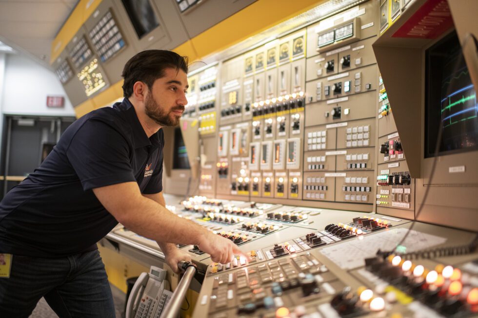 An employee of Laurentis Energy Partners in a nuclear control room.