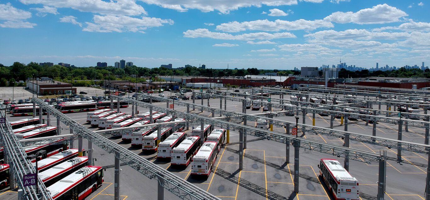 The garage, service area of parked TTC Buses. Operated by the Toronto Transit Commission. City public transit. Transportation buses parked in the special area.