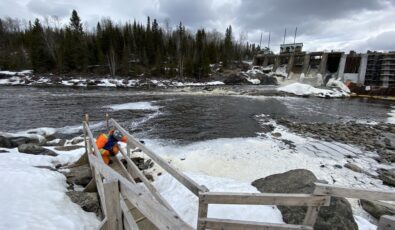 A worker from Timmins-based firm Blue Heron Environmental conducts environmental monitoring at the Frederick House Lake Dam.