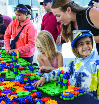 Community members take part in a kids activity at OPG's 2023 Community Power Expo.