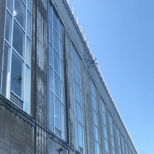 A drone cleans the powerhouse windows at OPG's Chats Falls hydro station in eastern Ontario.